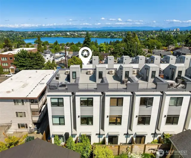Aerial view showcasing rooftop deck and views of Green Lake.