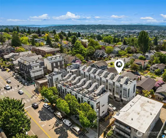 Aerial view of townhome showcasing prime location set back from street.