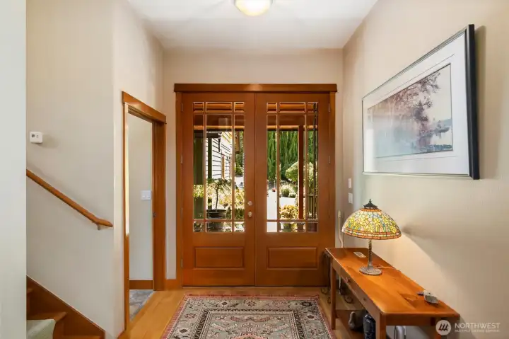 Enter home through beautiful French doors to wide and welcoming hall that leads to main living area.  Door on left leads to mudroom/pantry and on to three car garage.