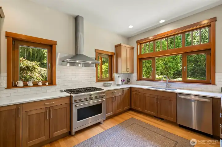 Viking range, tiled back splash, tons of counterspace.  A chef's dream with so many windows to enjoy your private acreage.