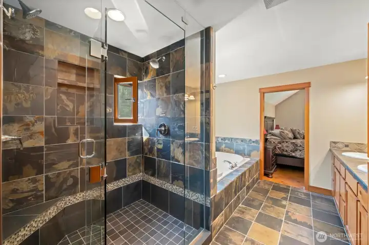 Primary bath features deep soaking tub, dual vanities and spa like walk in slate shower with seat.