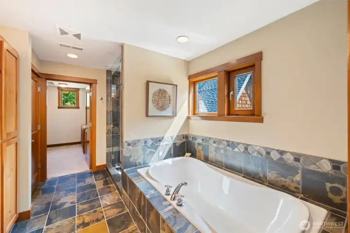 Generous walk in closet through bath along with a linen closet and extra storage.