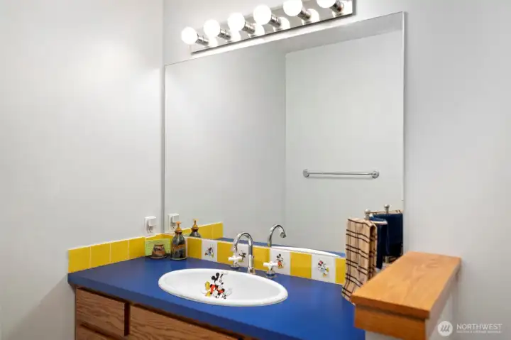 Playful secondary full bath upstairs near third and fourth bedrooms.