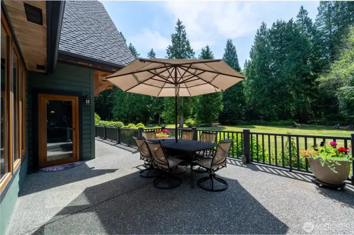 Exposed aggregate patio with newly stained deck railings. Such a wonderful place to entertain and relax.