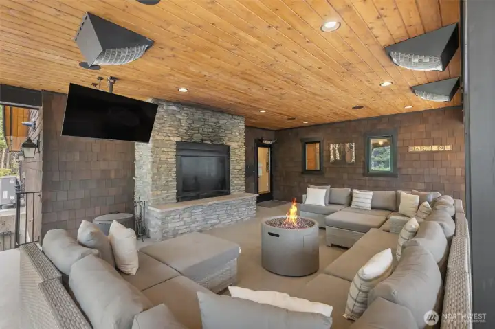 Covered deck with heaters, fireplace and TV.