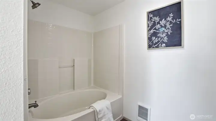 Relax and unwind in the large soaking tub featured in the primary bath.