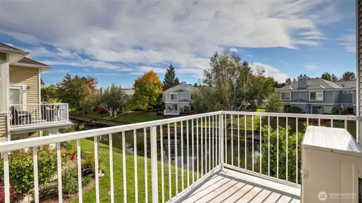 Relax and enjoy the breeze from this balcony overlooking lush green space and canal.