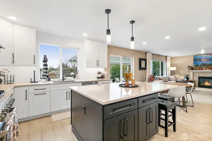 Beautiful quartz counters & two toned custom cabinetry with eating space off the island bar.
