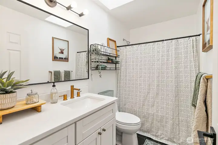 Full bathroom upstairs that has been completely remodeled with modern finishes.