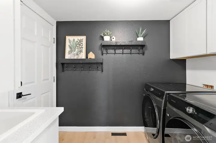Functional Utility room off of the garage includes a sink & cabinets for extra storage.