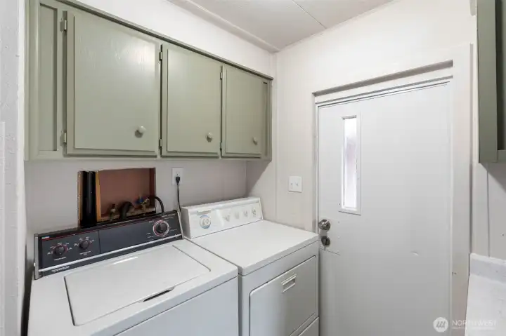 Utility room off kitchen with door to carport.