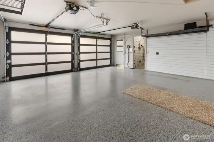 Garage updates continue with Epoxy Flooring, Slat Wall Panels for organization, Gorilla Racks for Storage, and EV Charger added in 2022 (down small hallway, not seen is extra refrigerator).