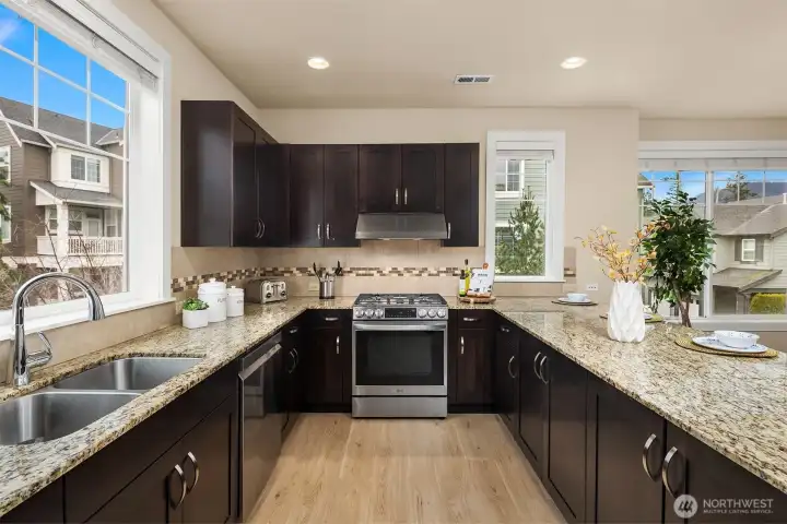 Newer stainless steel appliances and an abundance of cabinet and countertop space.