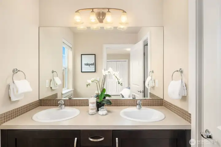 Dual vanities in the guest bathroom, with a door connecting to the shower/tub and toilet - optimizing privacy!