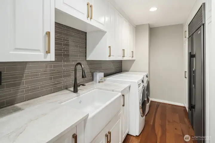 Beautifully appointed laundry room with additional refridgerator