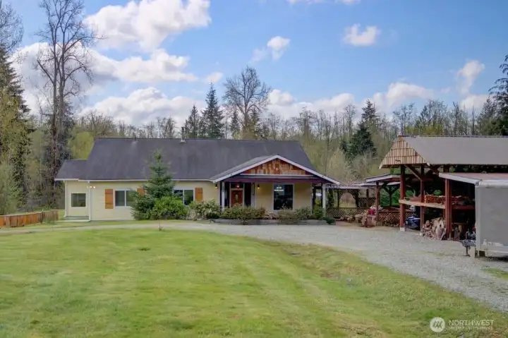 Front facing view of home. Gazebo and covered parking on the right.
