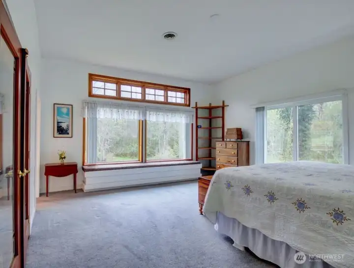 Primary bedroom with sliding doors to the backyard.