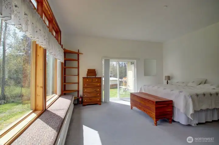 Another view of primary bedroom with sliding doors to backyard.