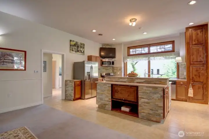 View of kitchen island w/ shelving & storage.