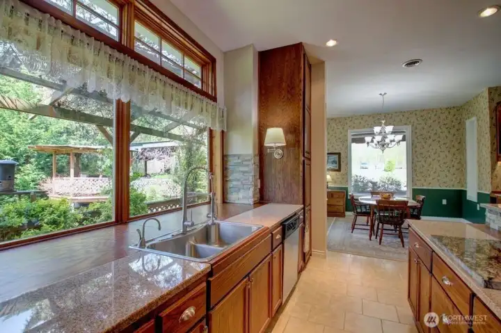 Kitchen looking out window towards the pergola/gazebo. The dining room off to the right.