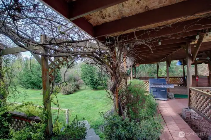 Pergola off the kitchen with walk way along side of the home.