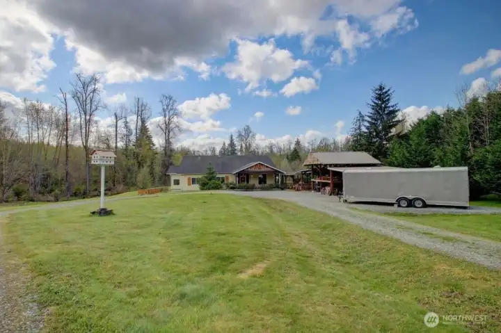 Front facing view of home with covered parking & RV/Trailer parking.