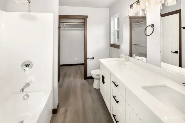 Primary en-suite bath...shower, tub, dual vanity quartz sinks and counter tops all with large walk in closet