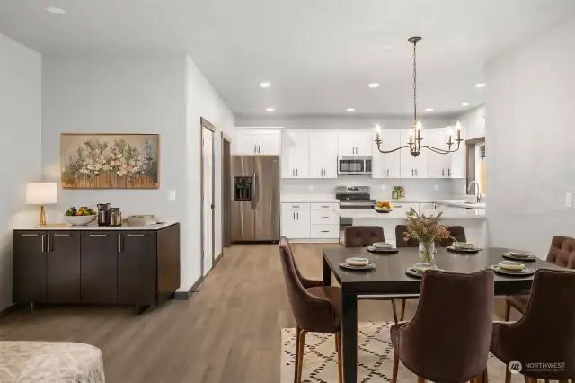 Photo of dining area and kitchen space "virtually staged"  gives you a great idea of all the room you have for your furniture in this home!