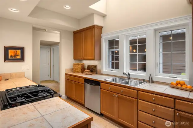 Skylights overhead with stainless steel appliances.