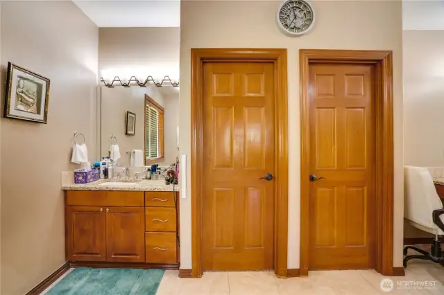 Dual walk-in closets are thoughtfully designed with integrated closet systems.