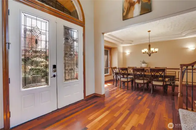 The morning sunshine streams through the intricate leaded glass details of the French doors, warmly inviting the start of a promising day.