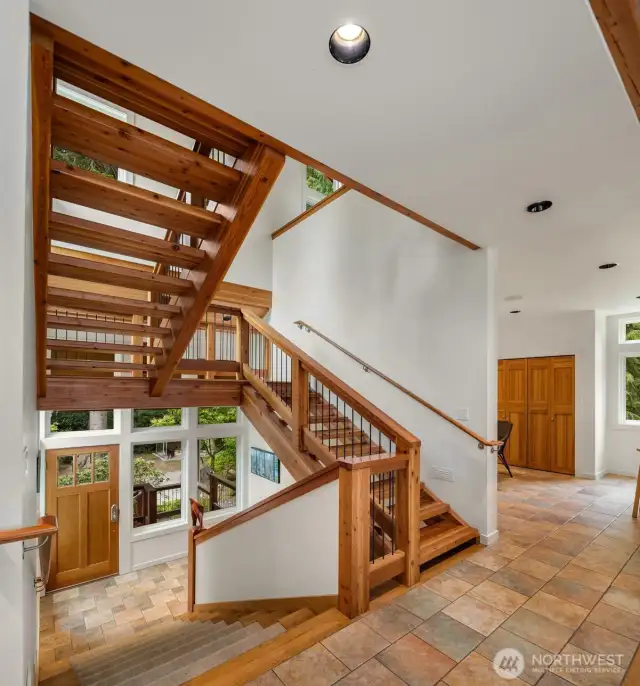 Inside, this magnificent extra wide staircase ascends to 3 levels with wall of glass to capture the landscape.