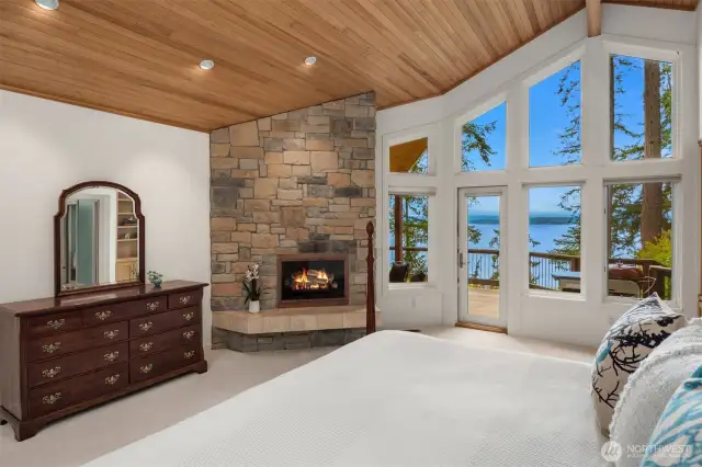 The primary suite is grand in scale and offers TWO walls of windows to capture both views, the waterside and the treed side. Amazing!