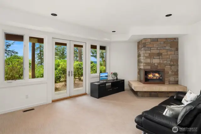 On the lower level, guests have their own space with walk-out patio, water views, and fireplace.