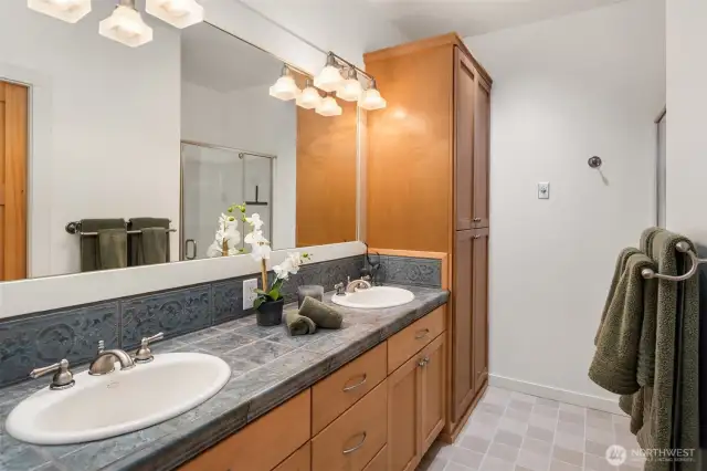 Dual sinks, large shower and a separate water closet.