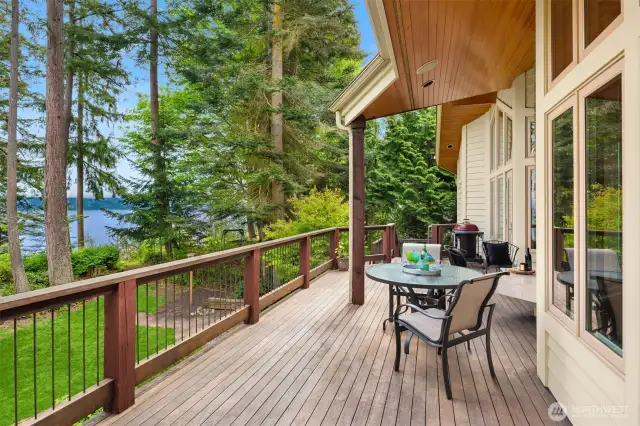 Outside a sprawling deck and hot tub with stairs that take you to the park side waterfront.