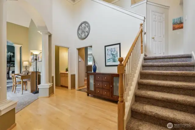The entry foyer graced with vaulted ceilings, plenty of natural light. and beautiful hardwood elements.