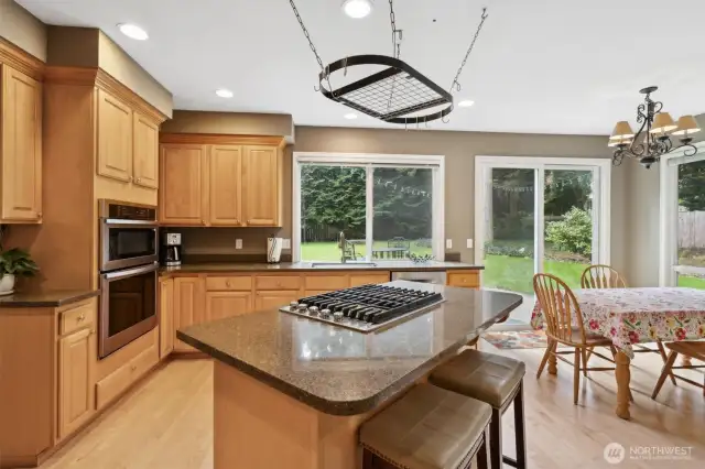 The kitchen and living spaces feature granite countertops and hardwood floors.