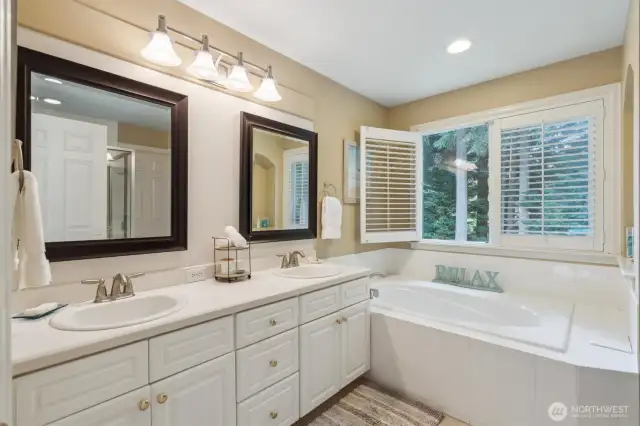 Double sinks and soaking tub featured in the primary bathroom.