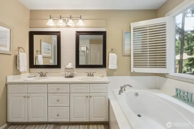 Unwind from a long day in a hot bath. Real wood plantation shutters have been installed throughout the home.