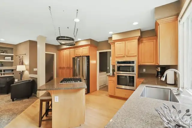 Beautiful natural wood cabinets featured throughout the kitchen.
