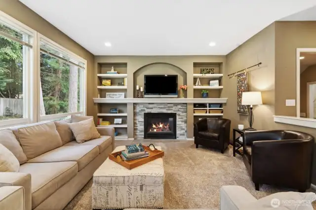 The Family Room feels both expansive and cozy with the large windows and connected spaces.