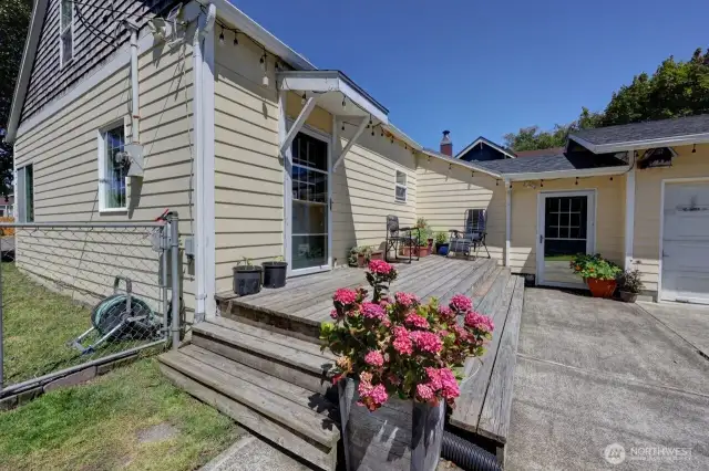 Your south side sunny deck with access to the paved driveway and 2 car garage