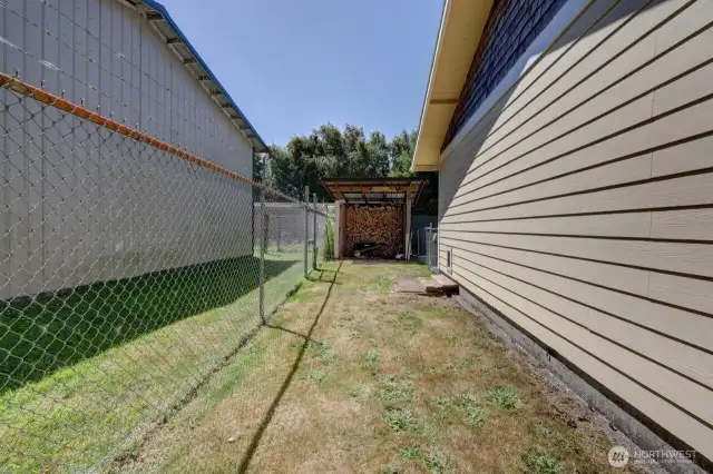 Fully fenced yard with wood storage