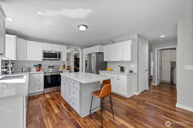Tastefully done Kitchen has plenty of cabinets & counter  space. Newer ss appliances.