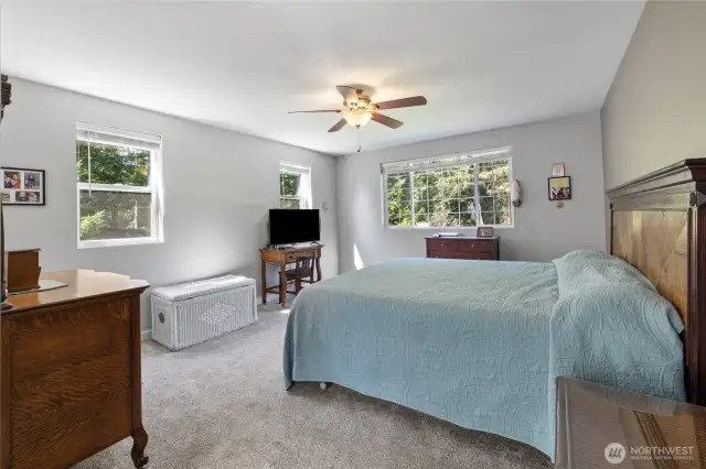 Primary bedroom is full of natural light