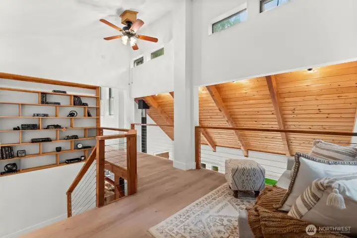 Upstairs, a custom bookcase stretches from top to bottom—both stylish and functional.