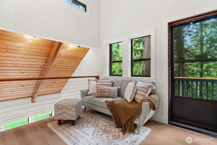 An upper-level sitting area opens to a private deck—perfect for relaxing.