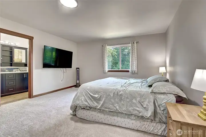 Large primary bedroom with new carpet and fresh updates throughout. A comfortable retreat with plenty of space to unwind at the end of the day.