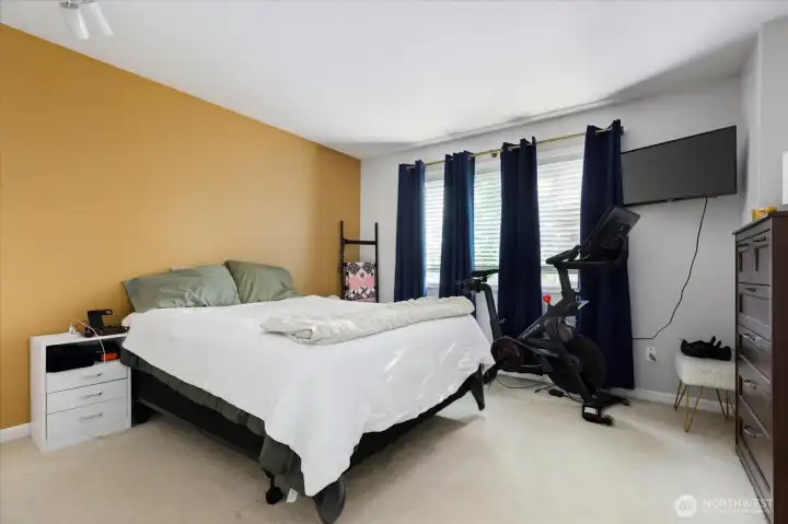 A spacious primary bedroom provides the perfect place to end your day.